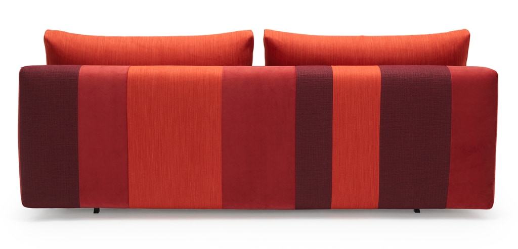 Conlix bäddsoffa, klädd i tyg Patchwork Blue, som soffa sedd bakifrån